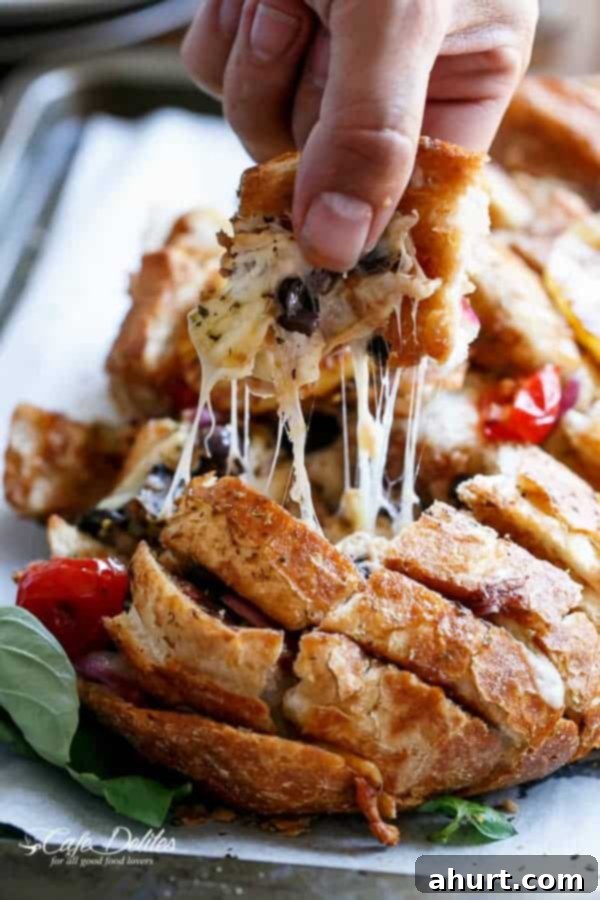 Loaded BBQ Chicken Pizza Pull-Apart Bread 10 A second piece being pulled from the Barbecue Chicken Pizza Stuffed Bread, showcasing the stretchy cheese.