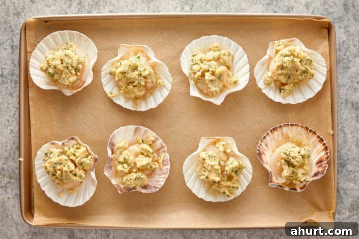 Adding garlic parsley butter on top of each scallop before baking.