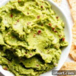 A bowl of the best creamy homemade guacamole, perfect for topping fajitas, tacos, or carnitas