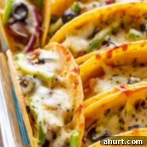 Oven Baked BBQ Chicken Pizza Tacos on a baking tray, a creative and fun taco fusion