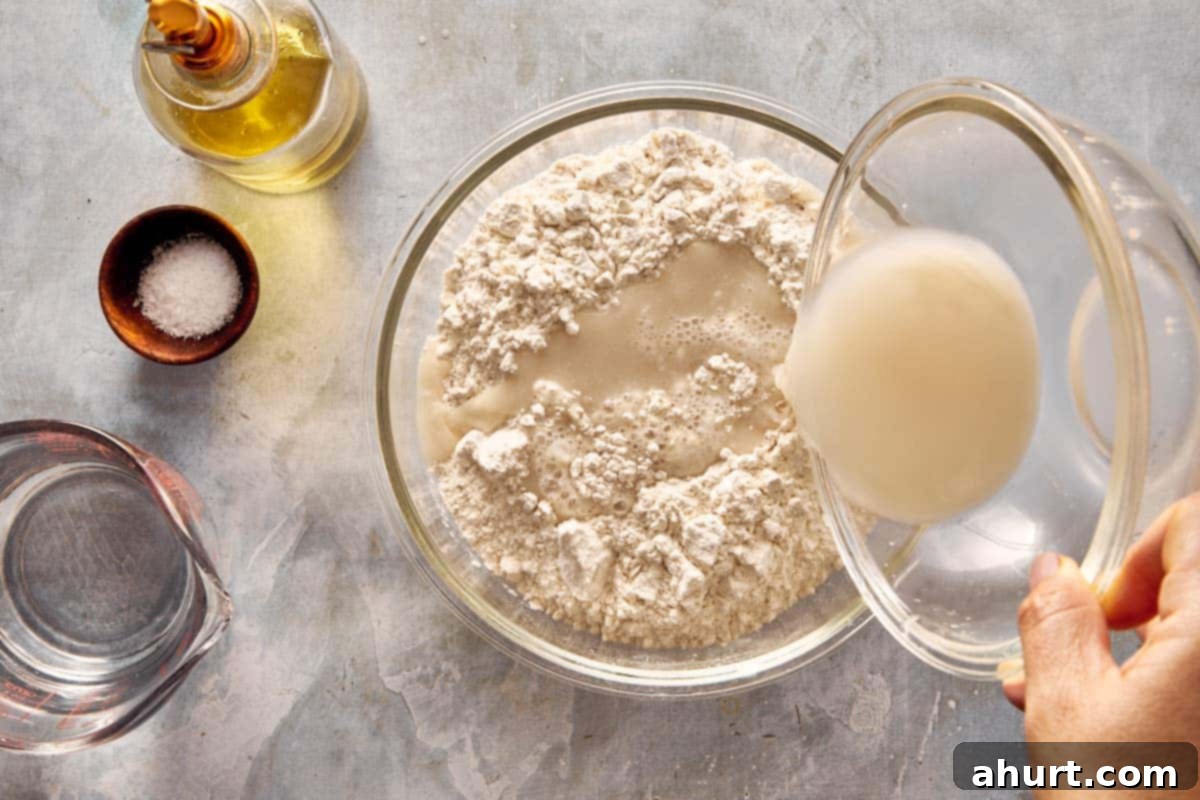 Focaccia-Style Pizza 4 Pouring yeast mixture into a bowl of flour to start making focaccia dough.