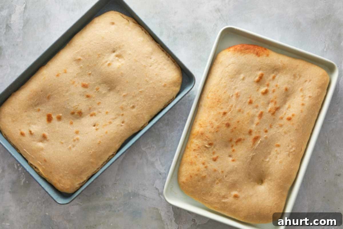 Focaccia-Style Pizza 7 Two trays of precooked focaccia bases with golden edges just out of the oven.