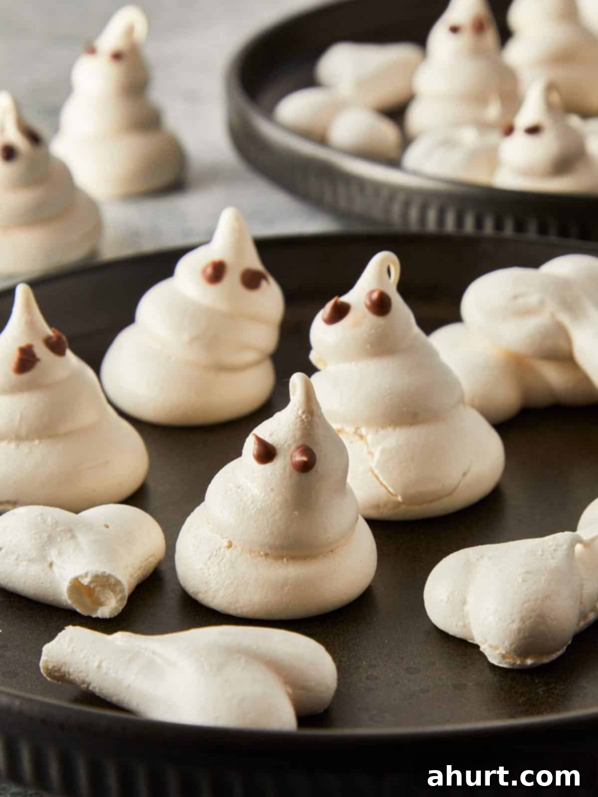 Plated Swiss meringue ghosts and bones ready to serve for Halloween.
