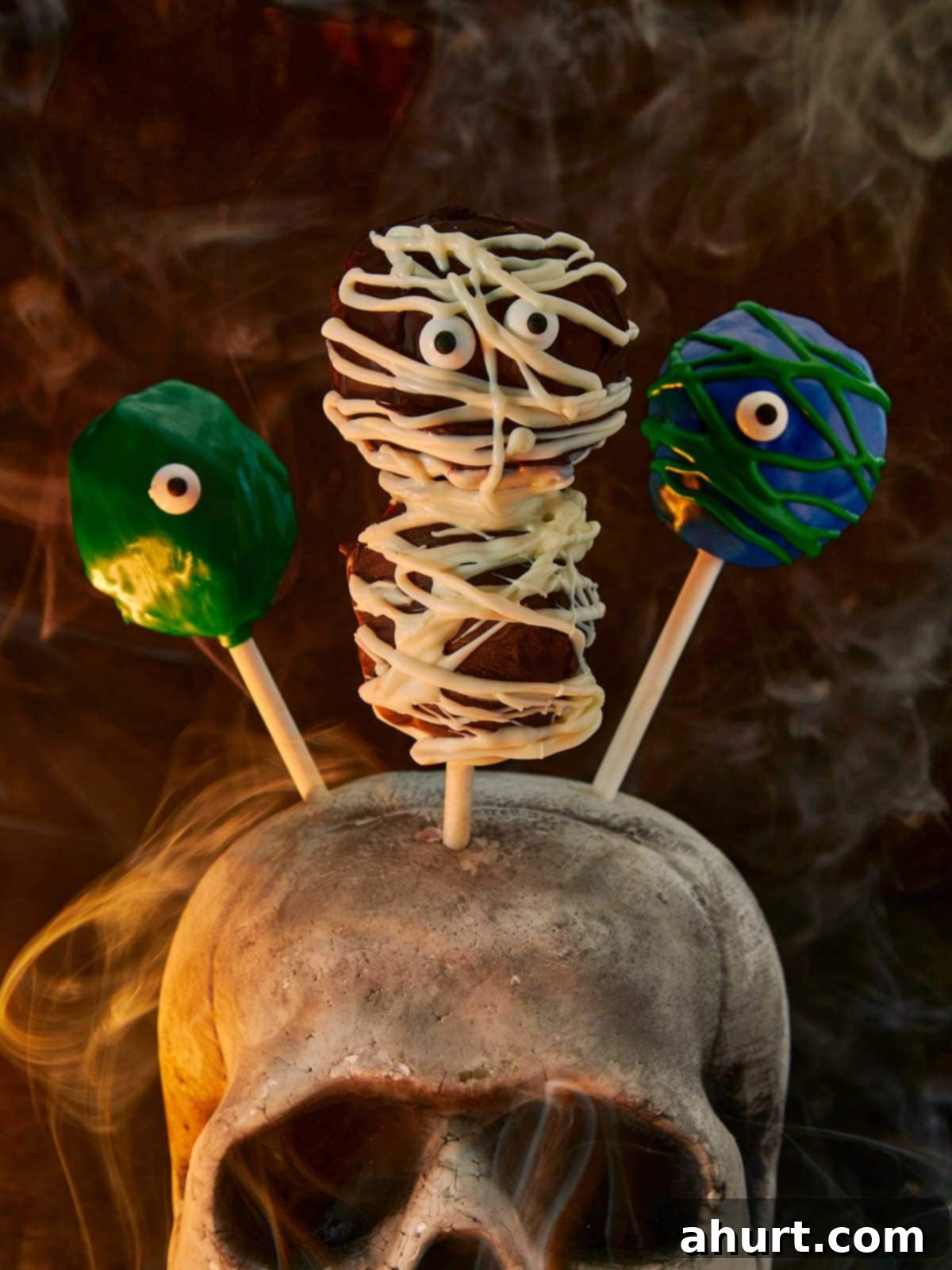 Spooktacular Red Velvet Cake Pops 2 Close up of a collection of whimsically decorated Red Velvet Monster Cake Pops, showcasing their vibrant red cake, smooth chocolate coating, and playful candy eyes, perfect for a Halloween party dessert.