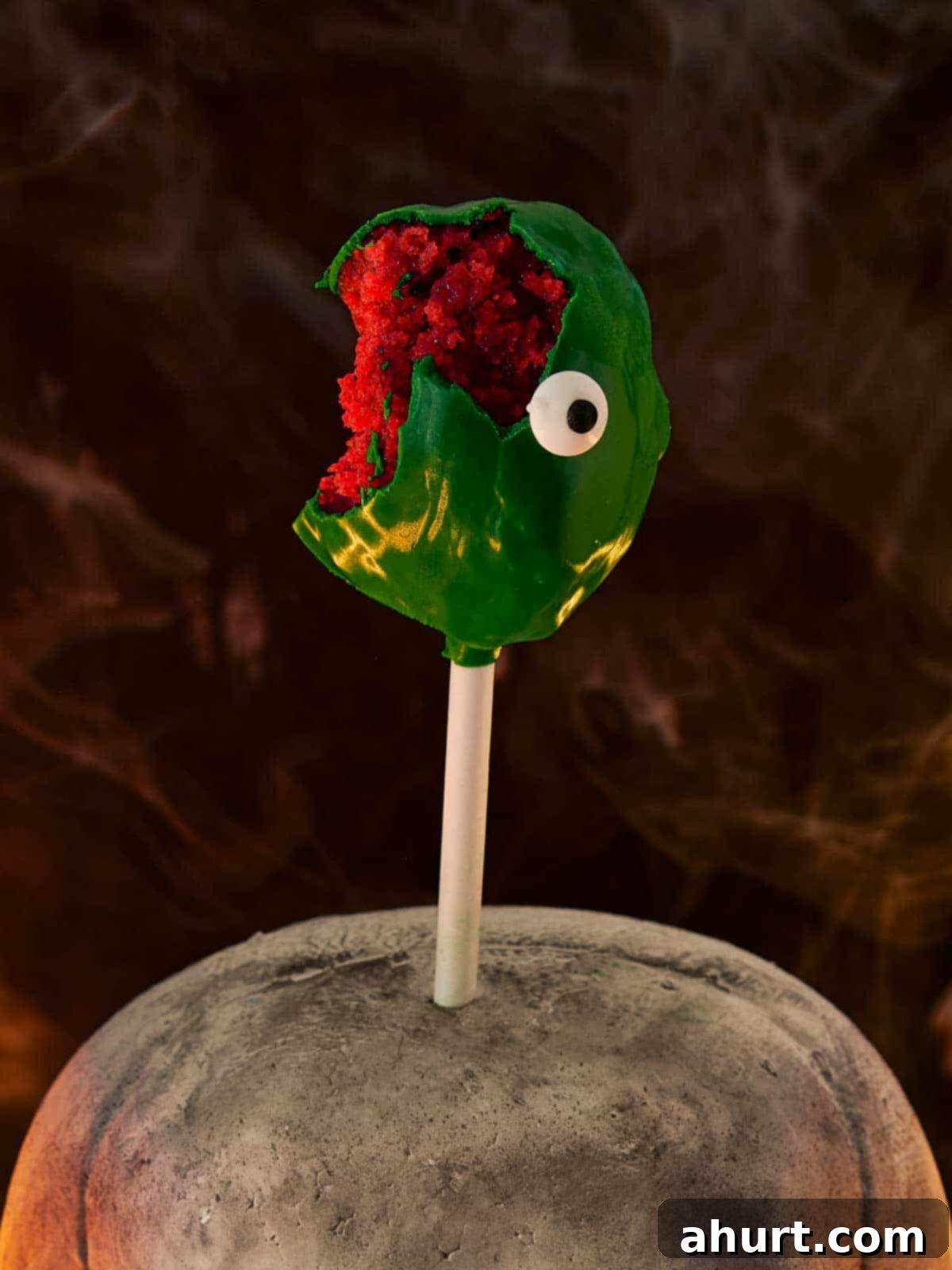 Spooktacular Red Velvet Cake Pops 10 A vibrant collection of Red Velvet Monster Cake Pops, each uniquely decorated with candy eyes and colorful sprinkles, arranged artfully, perfect for a fun and spooky Halloween treat display.