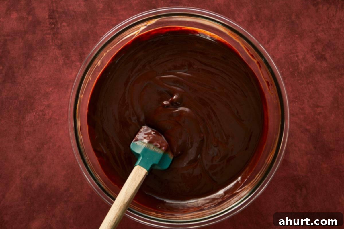 Whisking melted chocolate and cream together into a silky, rich ganache.