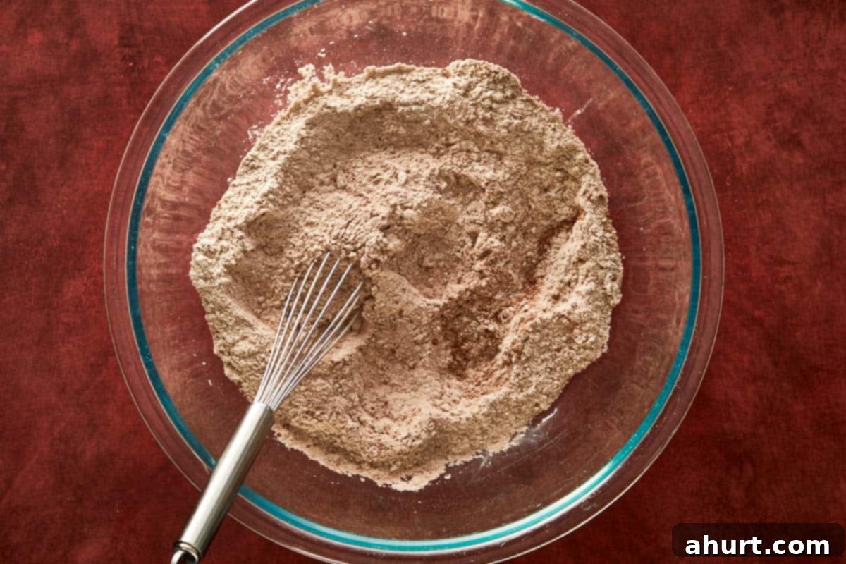 Mixing dry ingredients for cocoa chiffon cake — flour, cocoa, and sugar.