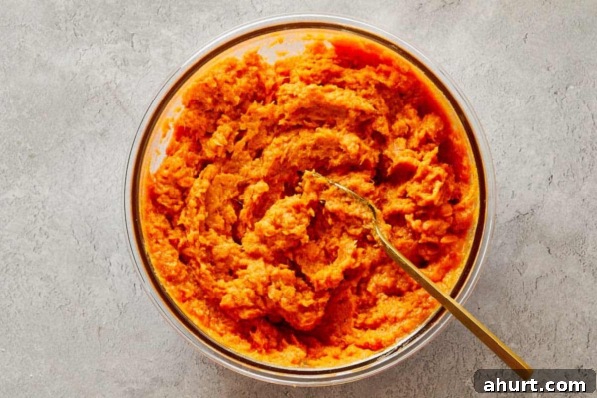Brown bowl filled with pecan streusel mixture made from brown sugar, butter, and chopped pecans.