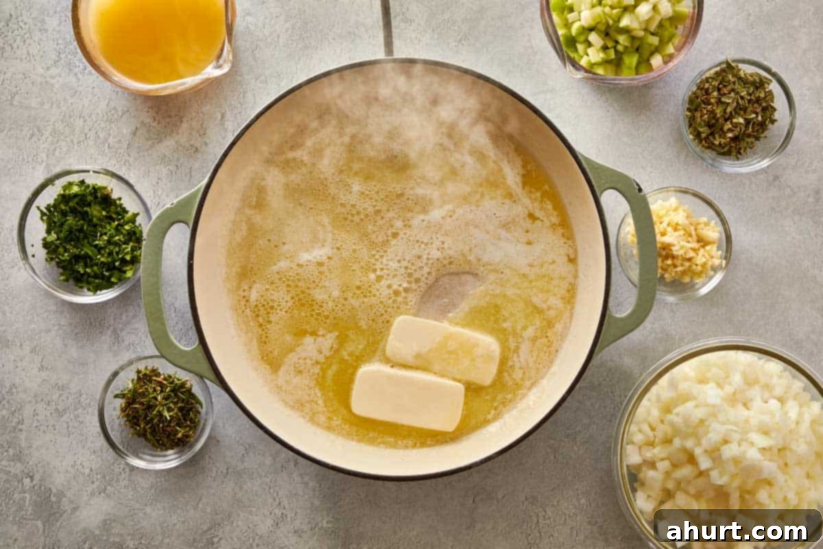 Classic Buttery Herb Stuffing 5 Melting butter in a large green pot, surrounded by bowls of chopped onions, celery, herbs, and broth for classic stuffing.