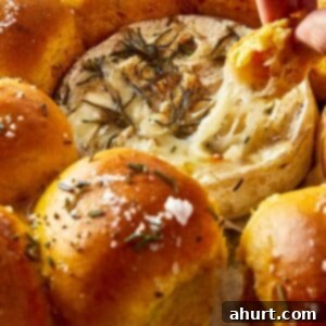 Close up of Sweet Potato Buns with Camembert Cheese, ready for dipping into the melted cheese.