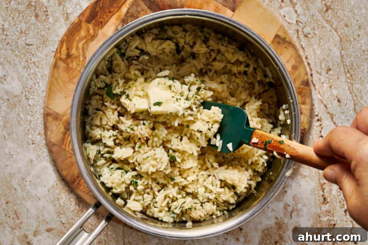 Simple and Flavorful Garlic Butter Rice 11 A pot of fully cooked, perfectly fluffed garlic butter rice, garnished with fresh parsley and ready to serve.
