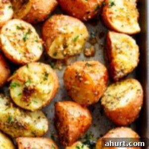 Master Your Thanksgiving 30 Recipes for a Perfect Feast 15 Golden brown crispy browned butter parmesan roasted potatoes, garnished with fresh herbs, showcasing their irresistible texture.