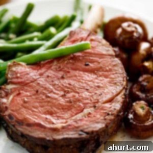 Master Your Thanksgiving 30 Recipes for a Perfect Feast 7 A stunning Prime Rib roast, richly coated in garlic butter, served alongside fresh green beans and savory mushrooms.