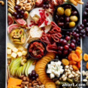 Master Your Thanksgiving 30 Recipes for a Perfect Feast 8 A beautifully arranged Loaded Thanksgiving Cheeseboard, featuring a variety of cheeses, crackers, seasonal fruits, and nuts, perfect for an easy holiday appetizer.