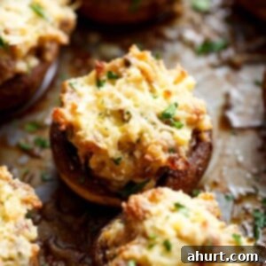 Master Your Thanksgiving 30 Recipes for a Perfect Feast 9 Savory Sausage Cream Cheese Dip Stuffed Mushrooms, baked until golden and bubbling, ready to be served.