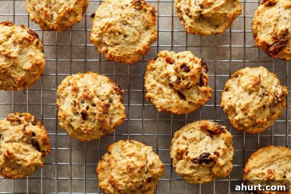 a collection of muffins sitting spaced out on a wire rack cooling