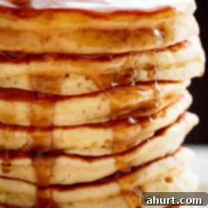 A tempting stack of Best Fluffy Pancakes, promising a soft and delightful breakfast experience.