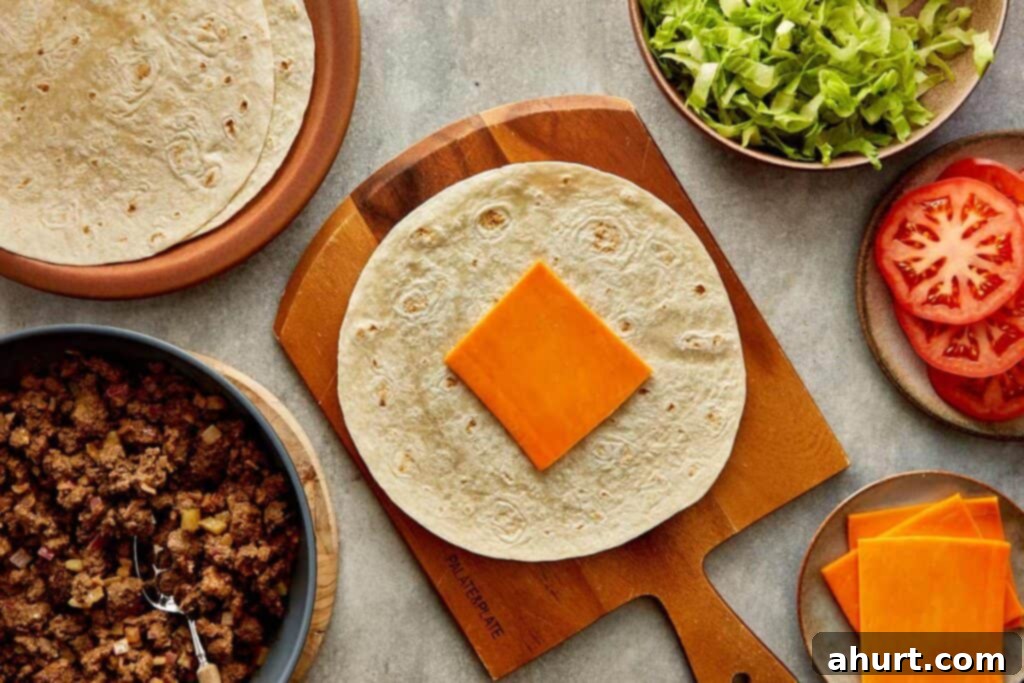 Cheeseburger Bliss Wrap 11 Tortilla wrap lying flat with a slice of cheese.