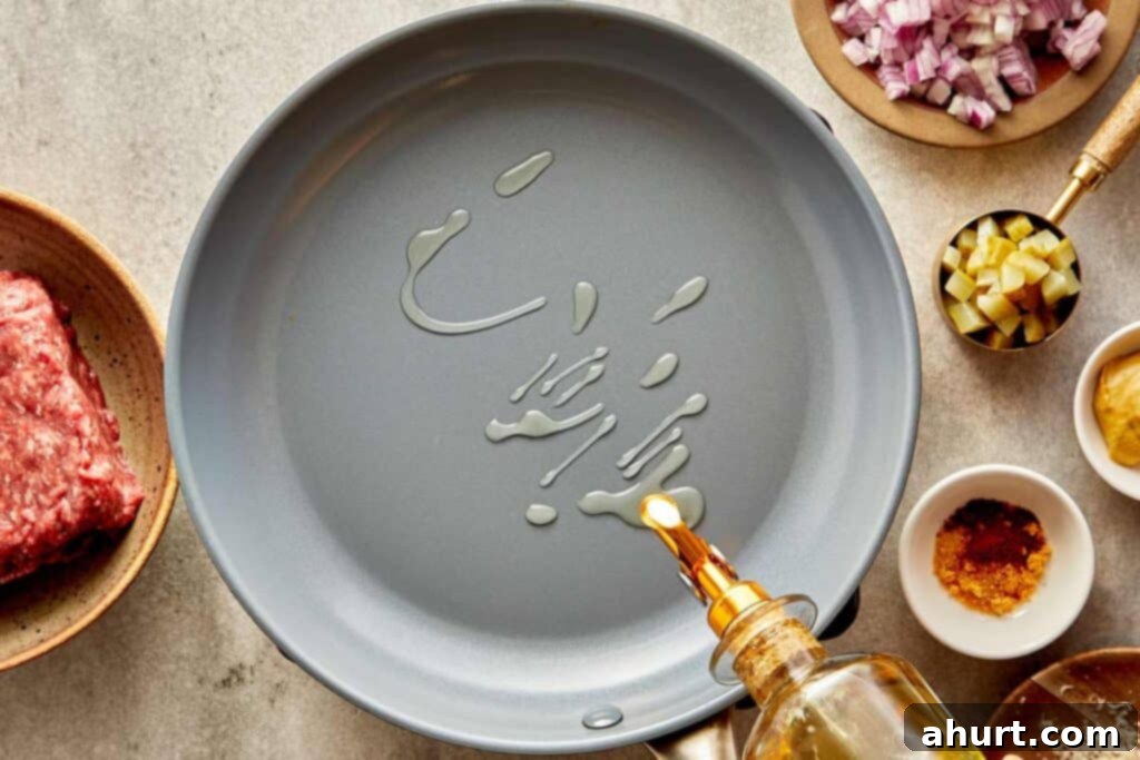 Cheeseburger Bliss Wrap 4 Olive oil being poured into an empty pan.