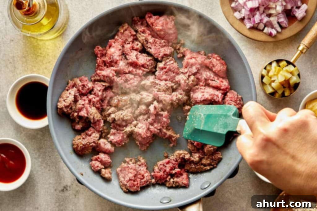 Cheeseburger Bliss Wrap 5 Ground meat being stirred in a frying pan.