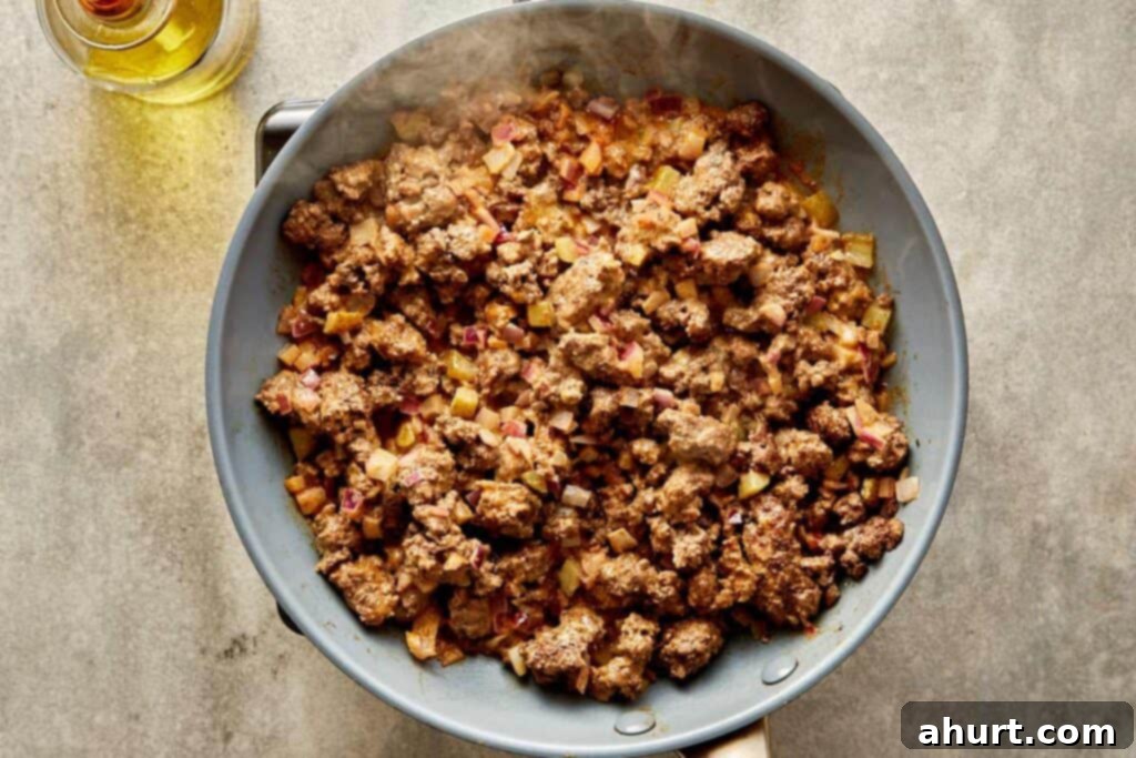 Cheeseburger Bliss Wrap 9 Pan filled with ground meat and cooked sauce.