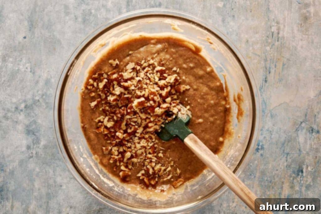 A top-down view of all the ingredients being mixed together in a large glass mixing bowl.