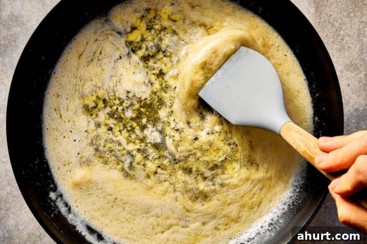 melting butter with garlic in pan for garlic parmesan sauce